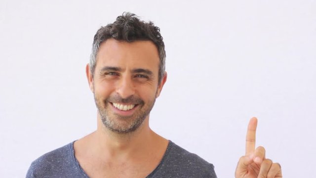 Man similing at the camera and pointing