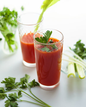 Tomato juice in glasses on white backround