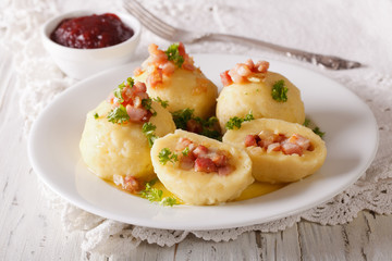Tasty potato dumplings with bacon and parsley topped with butter. horizontal
