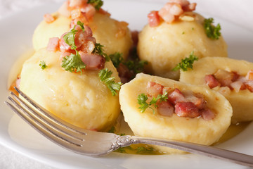Fototapeta na wymiar Potato dumplings stuffed with ham, bacon and onion close-up. horizontal 