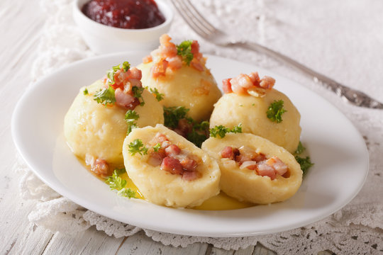 potato dumplings with bacon, butter and parsley close-up. horizontal
