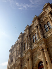 Looking at sky from the bottom of Dolmabahce Palace. Seagulls are flying above the palace