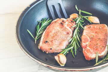 Raw fresh meat and seasoning on dark background