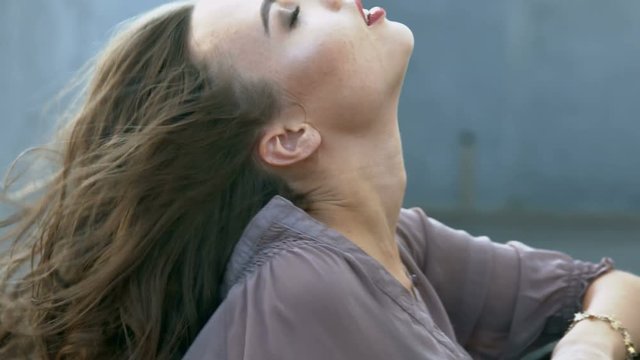 Sexy young woman posing for a fashion magazine in the car 