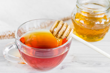 cup of tea with honey on a wooden table