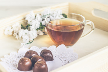 Tea and sweets on a wooden tray