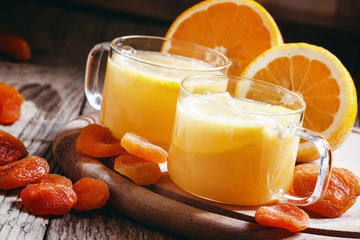 Alcoholic cocktail hot gold with amaretto liqueur, orange juice,