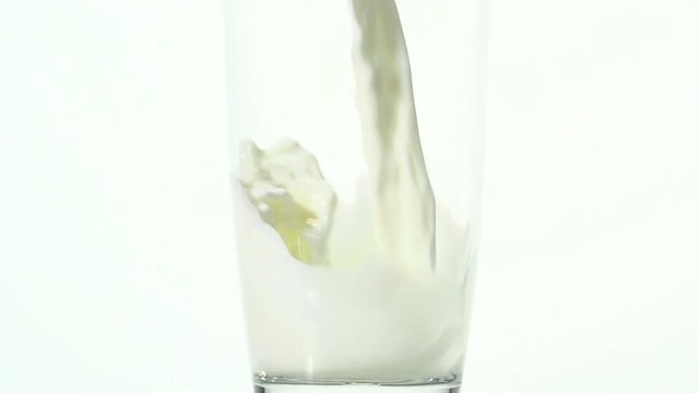 Slow motion close up of milk pouring into a glass. Shot at 240 frames per second. Shot can be sped up to play at normal speed.