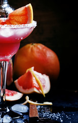 Grapefruit daiquiri with salt, metal shaker, black background, s
