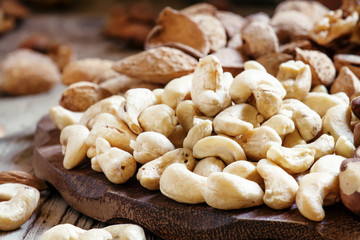 Raw cashew nut in the set, vintage wooden background, selective