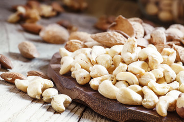 Raw cashew nut in the set, vintage wooden background, selective