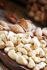 Raw cashew nut in the set, vintage wooden background, selective