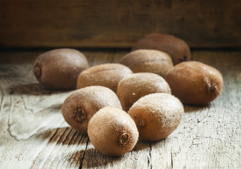 Kiwi fruit on vintage wooden background, selective focus