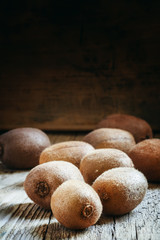 Kiwi fruit on vintage wooden background, selective focus