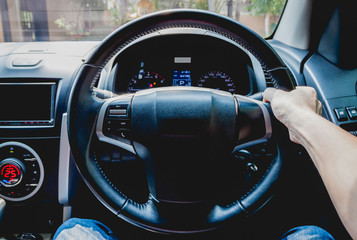 Hand holding a steering wheel