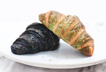 Asian woman eating Charcoal and green tea croissants