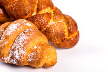 pile of fresh and delicious kroissants and rolls on a white back