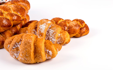 pile of fresh and delicious kroissants and rolls on a white back