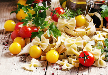 Farfalle pasta, parsley and spices, red and yellow cherry tomato