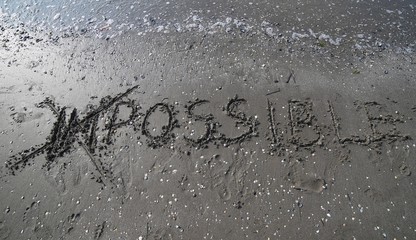 ANY QUESTIONS written on the sand