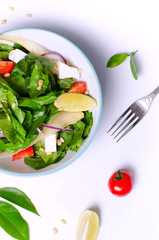 Healthy spinach salad with a top with a cocktail. Authentic fresh salad. Vegetable salad.