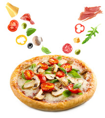 Delicious pizza with falling vegetables and pieces of meat, isolated on white