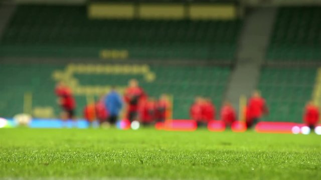 Unfocused background footage of soccer players warming up before the match