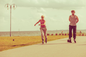 Teenagers together on skates.