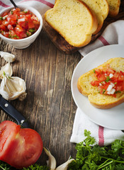 Garlic bread  topped with tomato, garlic and herbs