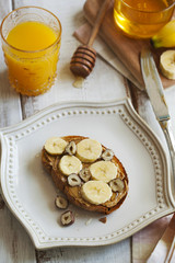 Toast with bananas, peanut butter, nuts and honey