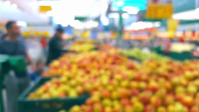 Supermarket interior with buyers, defocused blurred background