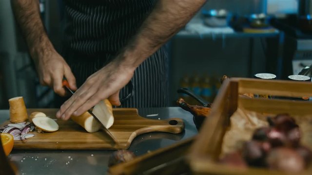 Chef cutting the parsnip. 60 FPS slow motion shot. Blackmagic URSA Mini
