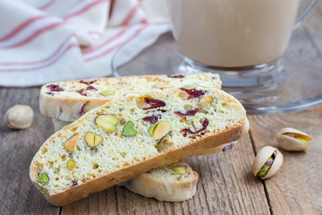 Biscotti with cranberry and pistachio with cup of coffee latte, closeup