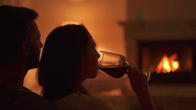 4k footage, closeup legs of young couple sitting at poolside splash around in water
