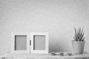 Vintage wooden photo frame with Haworthia Fasciata and pine cone