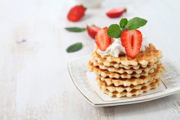 Waffles, mint and ripe strawberries.