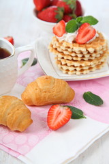 Delicious breakfast with strawberries and croissants