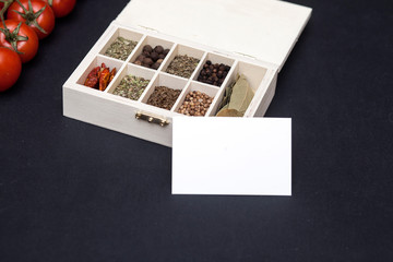 Business card and box with spices on the table
