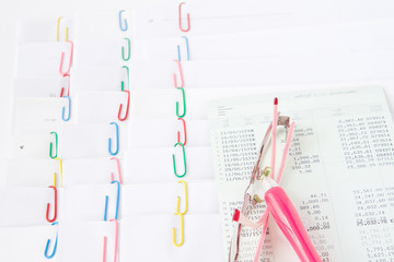 Spectacles and pen with book bank