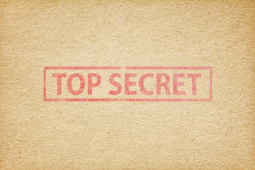 Top secret stamp on the brown paper background