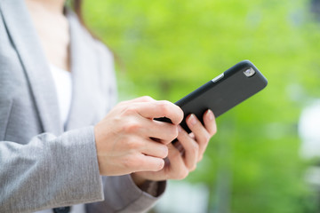 Business woman use of cellphone over green background