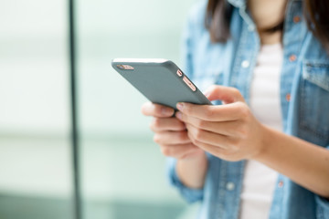 Woman use of cellphone inside modern office