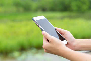 Woman hold with cellphone over green background