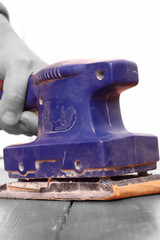 Sanding wood floorboard / Man sanding wooden floorboard with electric sander