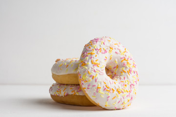 Donut with sprinkles on the white background