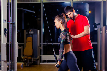 Fototapeta na wymiar Gym woman exercising with her personal trainer