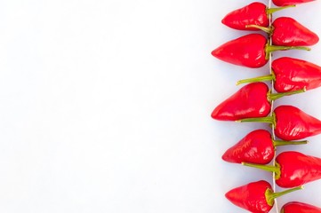 Group of fresh red hot chilli peppers on a white background. Healthy food. Fresh vegetables. Space on left side. Close-up view