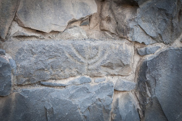 Ancient depiction of menorah in the ruins of the Talmudic-era synagogue in Katzrin.