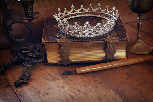 low key image of diamond queen crown on old book
