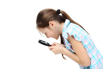 Young girl with magnifying glass on a white background